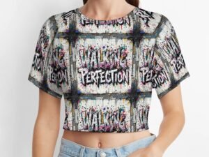 "Walking Perfection" Women`s Short T-Shirt with an all-over print in gray background with white letters with bold black outlines and pink and dark gray shading in a graffiti style